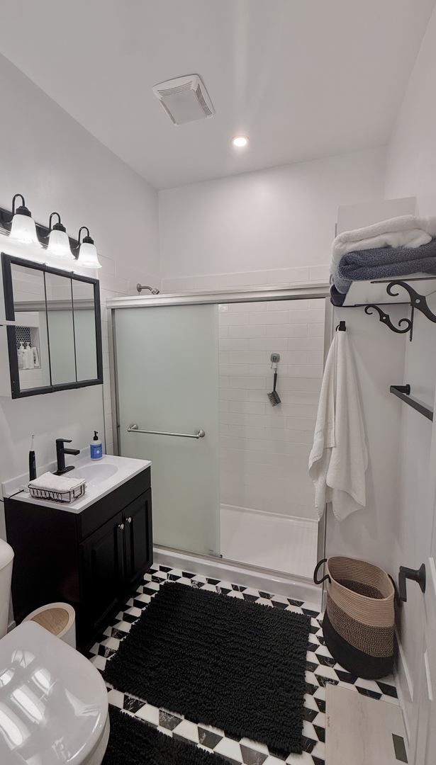 948 West Addison Street, Unit 3 Chicago, IL 60613 - Photo 9 of 11 a bathroom with a sink and a mirror