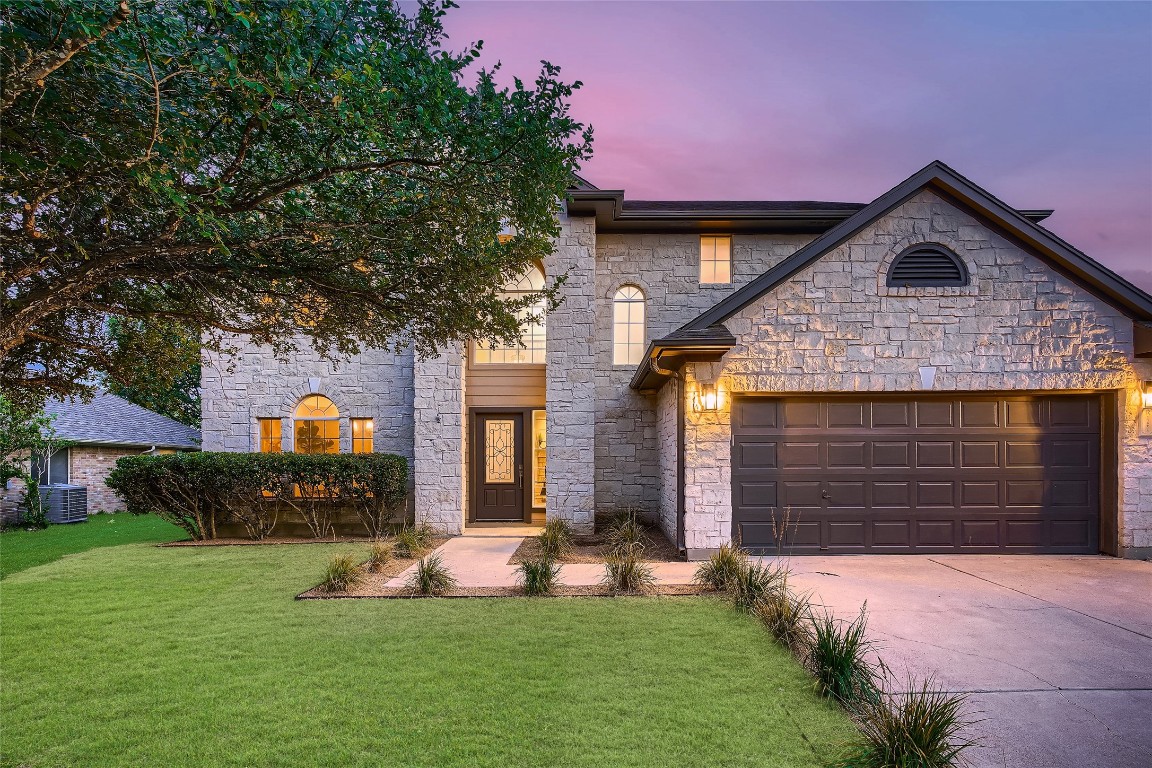 a front view of a house with a yard and garage