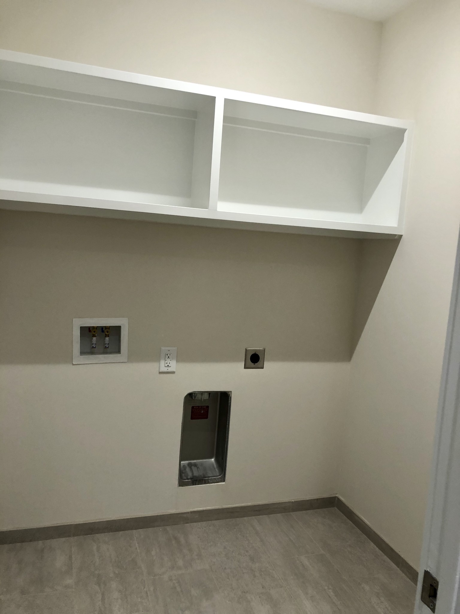 20 Rutledge Street, Unit 603 Nashville, TN 37210 - Photo 20 of 27 a utility room with a refrigerator and cabinets