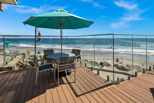 a view of a balcony with chairs and wooden floor