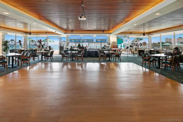 a view of a lake with a building and trees in the background