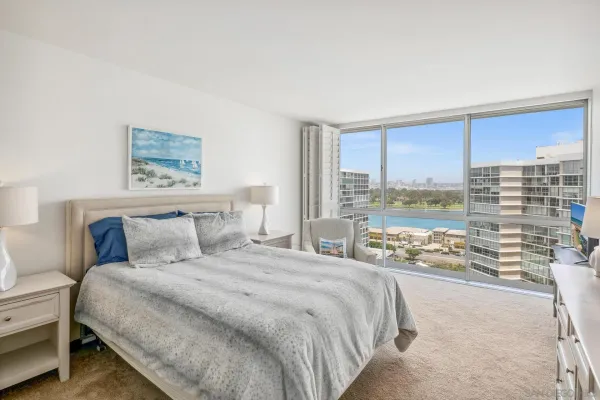 a bedroom with a large bed and a large window