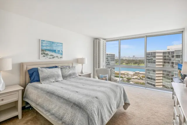 a bedroom with a large bed and a large window