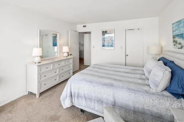 a bedroom with a bed and a dresser