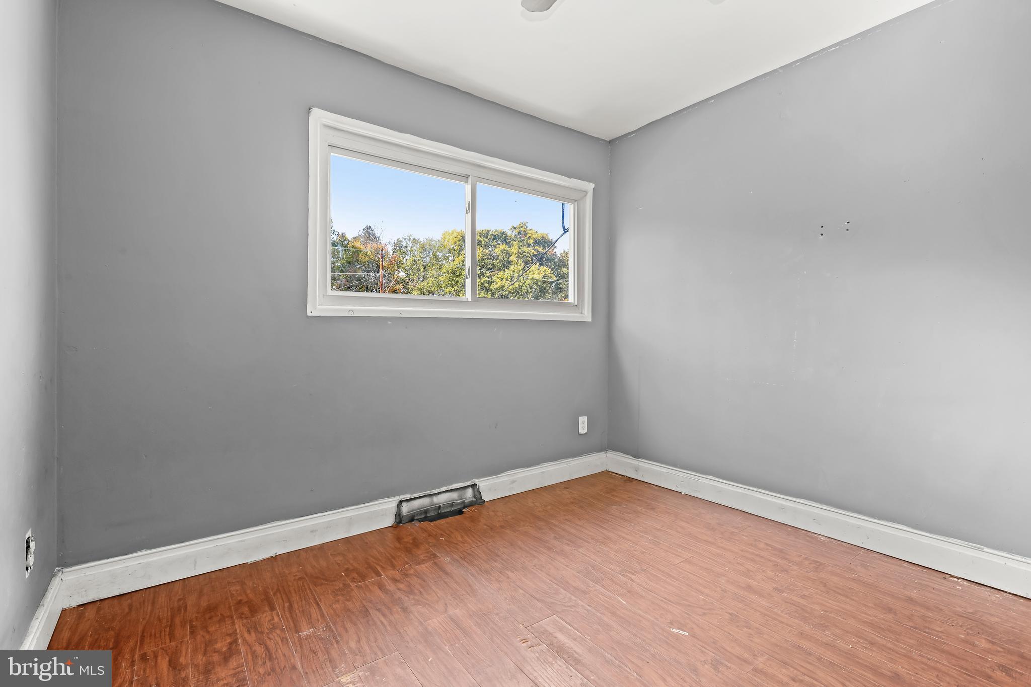 2217 Columbia Place Landover, MD 20785 - Photo 15 of 34 a view of an empty room with wooden floor and a window