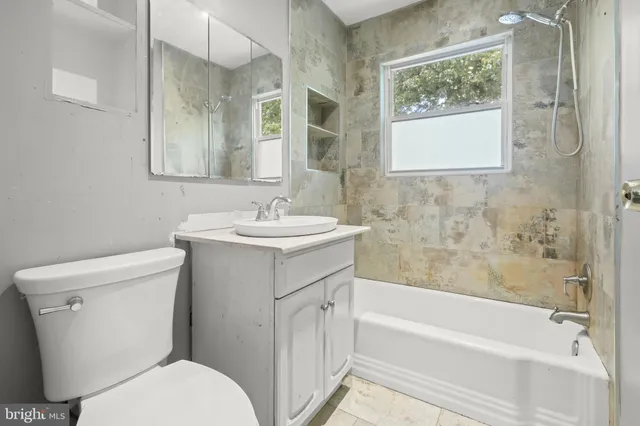 a bathroom with a sink toilet and vanity