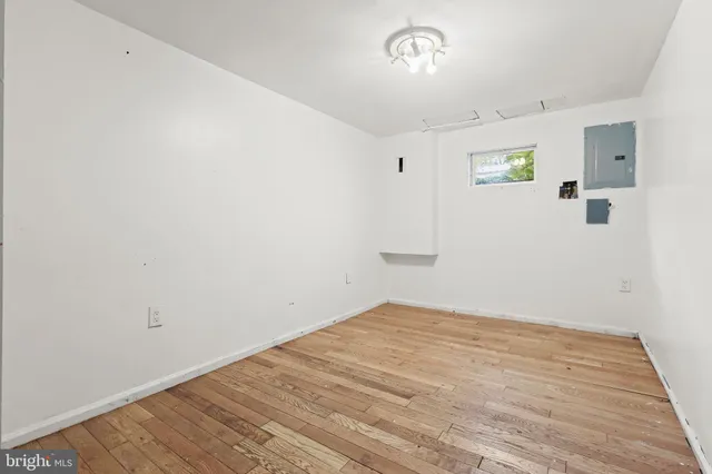 a view of empty room with wooden floor