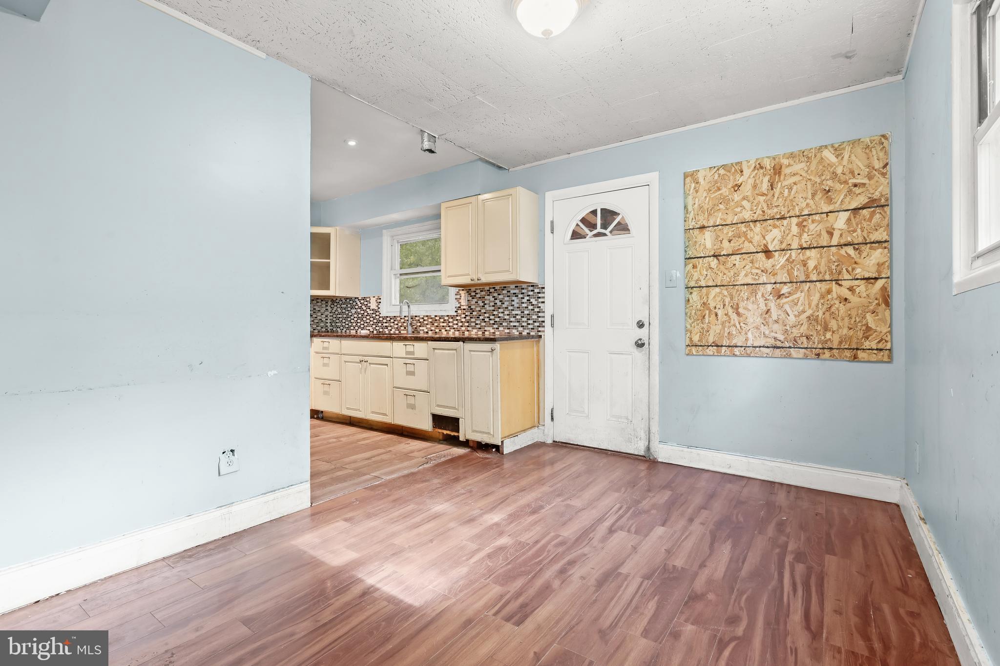 2217 Columbia Place Landover, MD 20785 - Photo 6 of 34 an empty room with wooden floor and windows