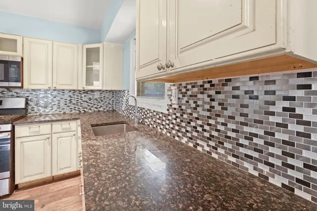 a bathroom with a sink a vanity and a shower