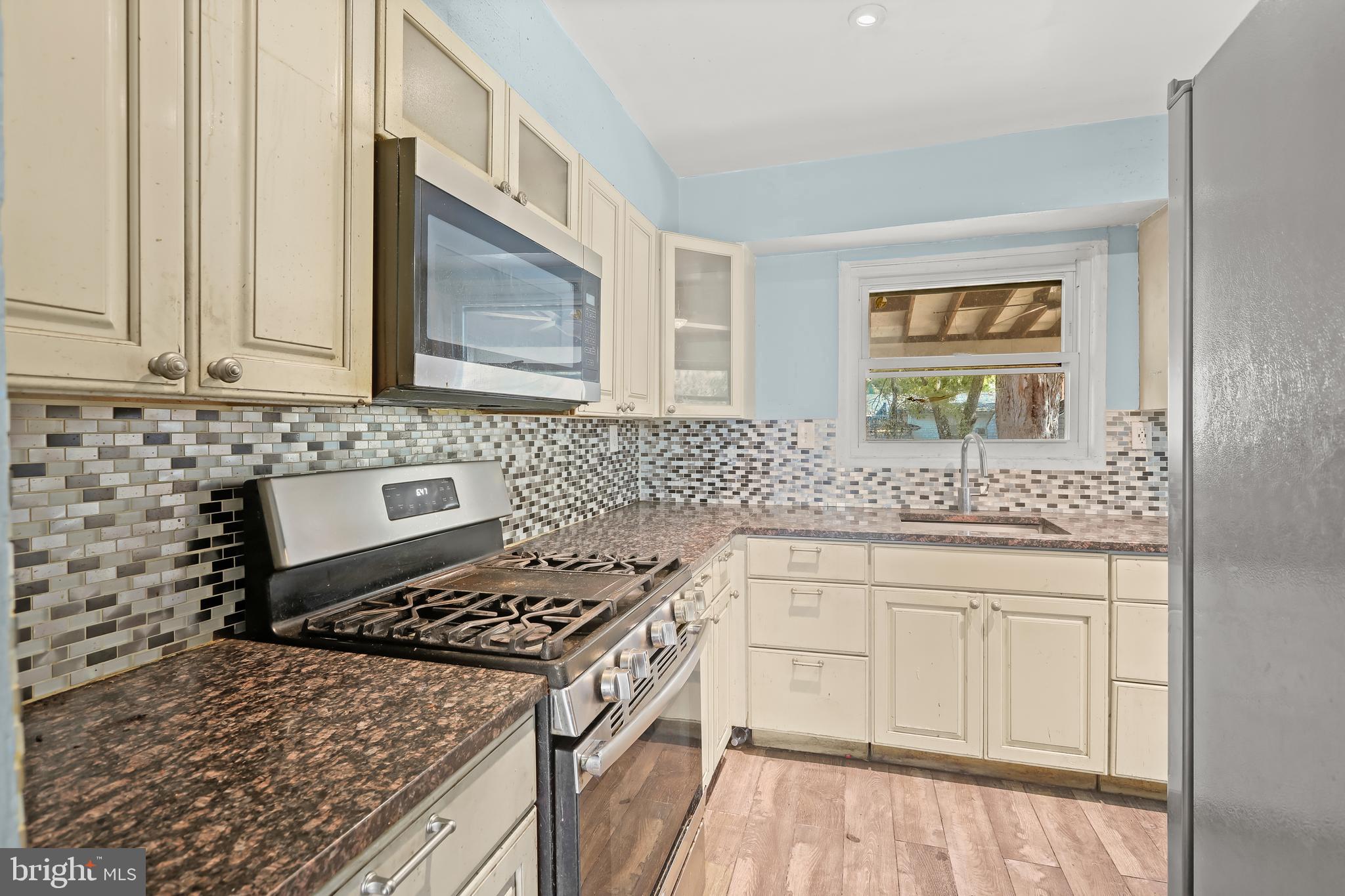 2217 Columbia Place Landover, MD 20785 - Photo 10 of 34 a kitchen with granite countertop a sink stove and cabinets