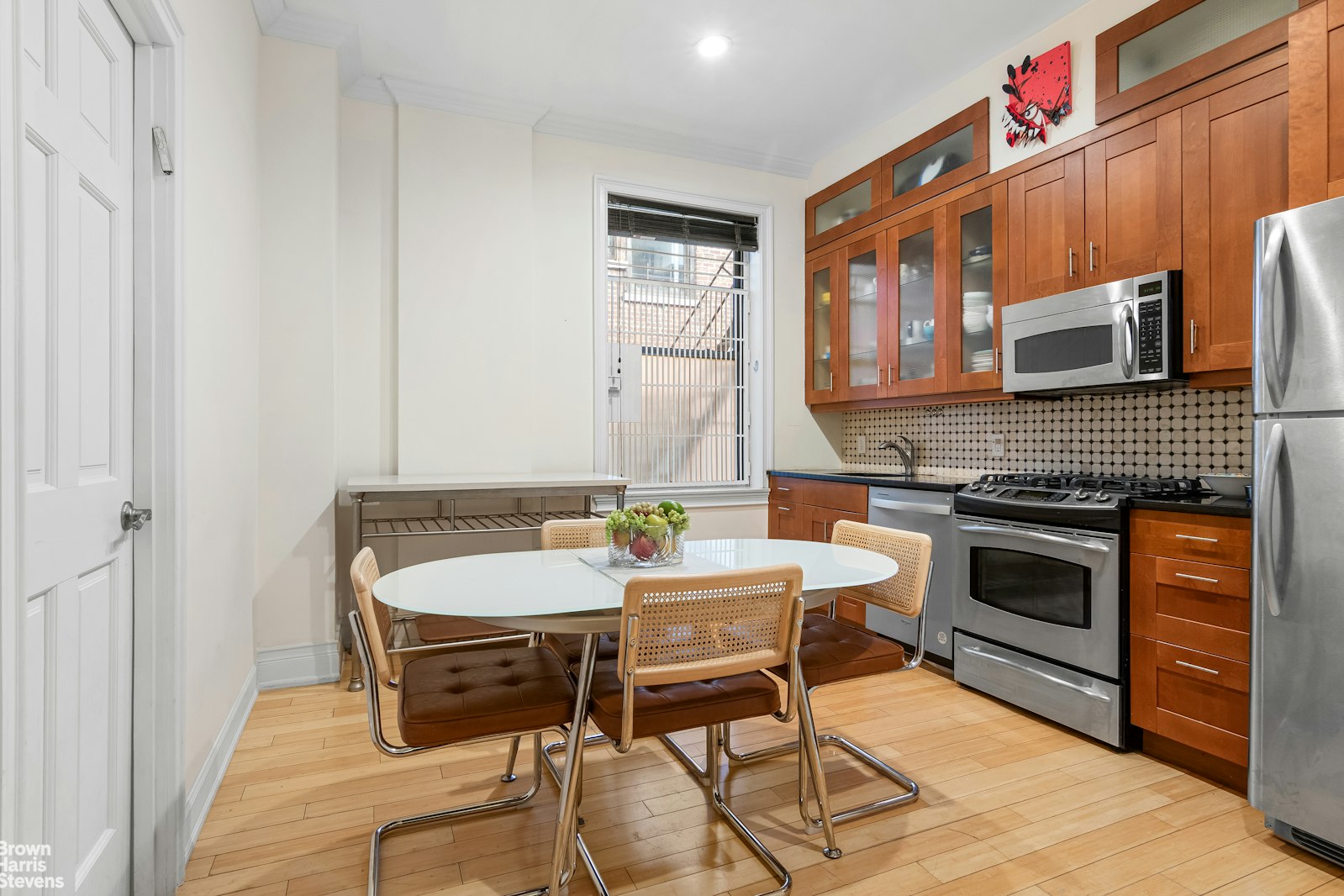 229 West 97th Street, Unit 6E Manhattan, NY 10025 - Photo 12 of 21 a kitchen with a dining table and chairs