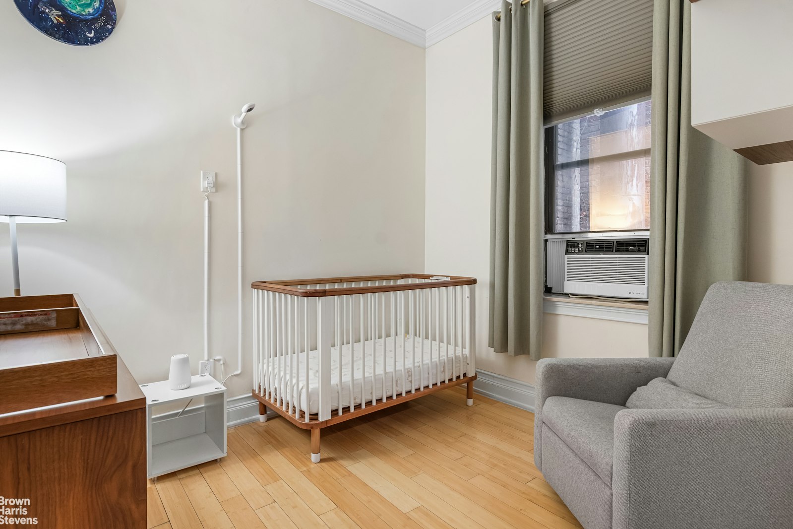 229 West 97th Street, Unit 6E Manhattan, NY 10025 - Photo 14 of 21 a living room with a baby crib furniture and a window