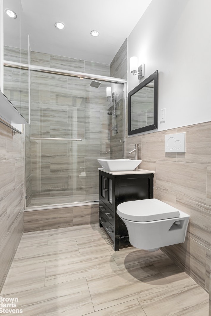 229 West 97th Street, Unit 6E Manhattan, NY 10025 - Photo 17 of 21 a bathroom with a sink toilet and shower