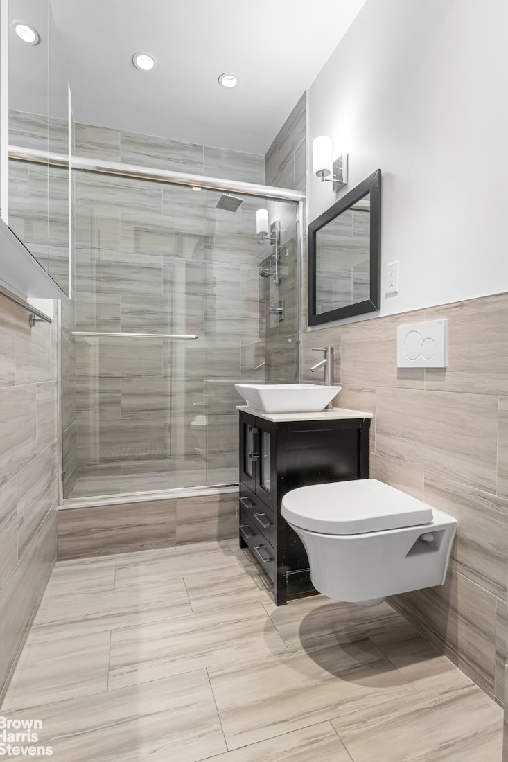 229 West 97th Street, Unit 6E Manhattan, NY 10025 - Photo 7 of 21 a bathroom with a sink toilet and shower