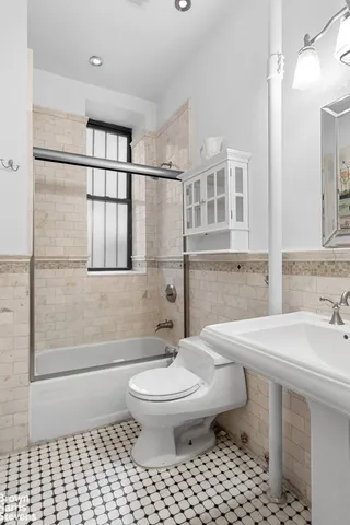 a bathroom with a bathtub and a window