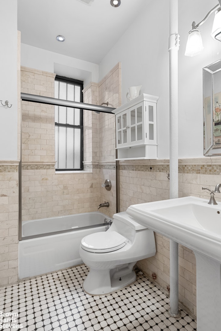 229 West 97th Street, Unit 6E Manhattan, NY 10025 - Photo 8 of 21 a bathroom with a sink toilet and shower