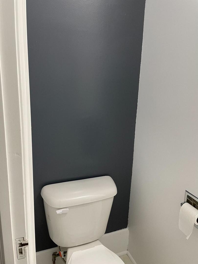 718 1/2 Columbus Street, Unit 2 Ottawa, IL 61350 - Photo 11 of 13 a white toilet sitting next to a white wall