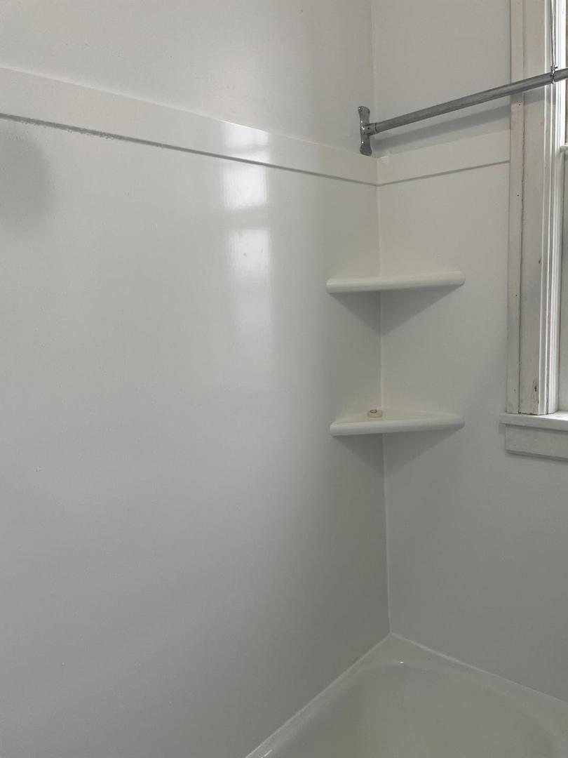 718 1/2 Columbus Street, Unit 2 Ottawa, IL 61350 - Photo 13 of 13 a bathroom with a glass shower door