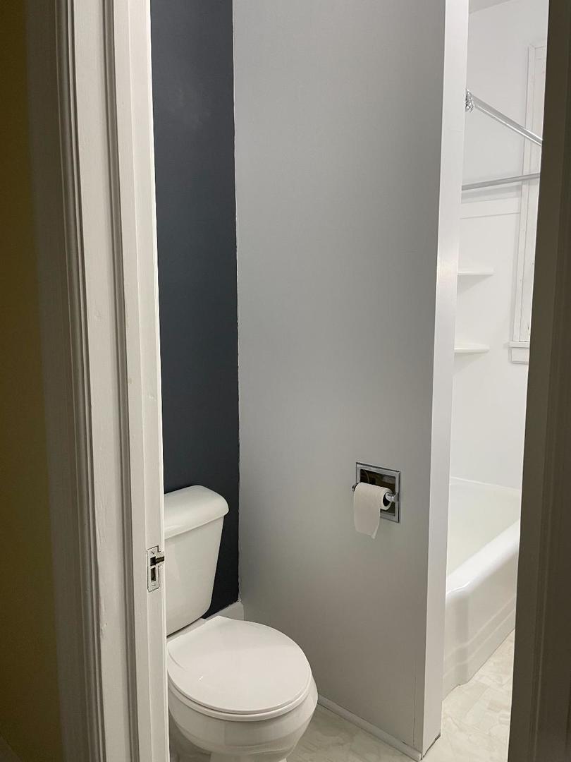718 1/2 Columbus Street, Unit 2 Ottawa, IL 61350 - Photo 10 of 13 a white toilet sitting next to a shower