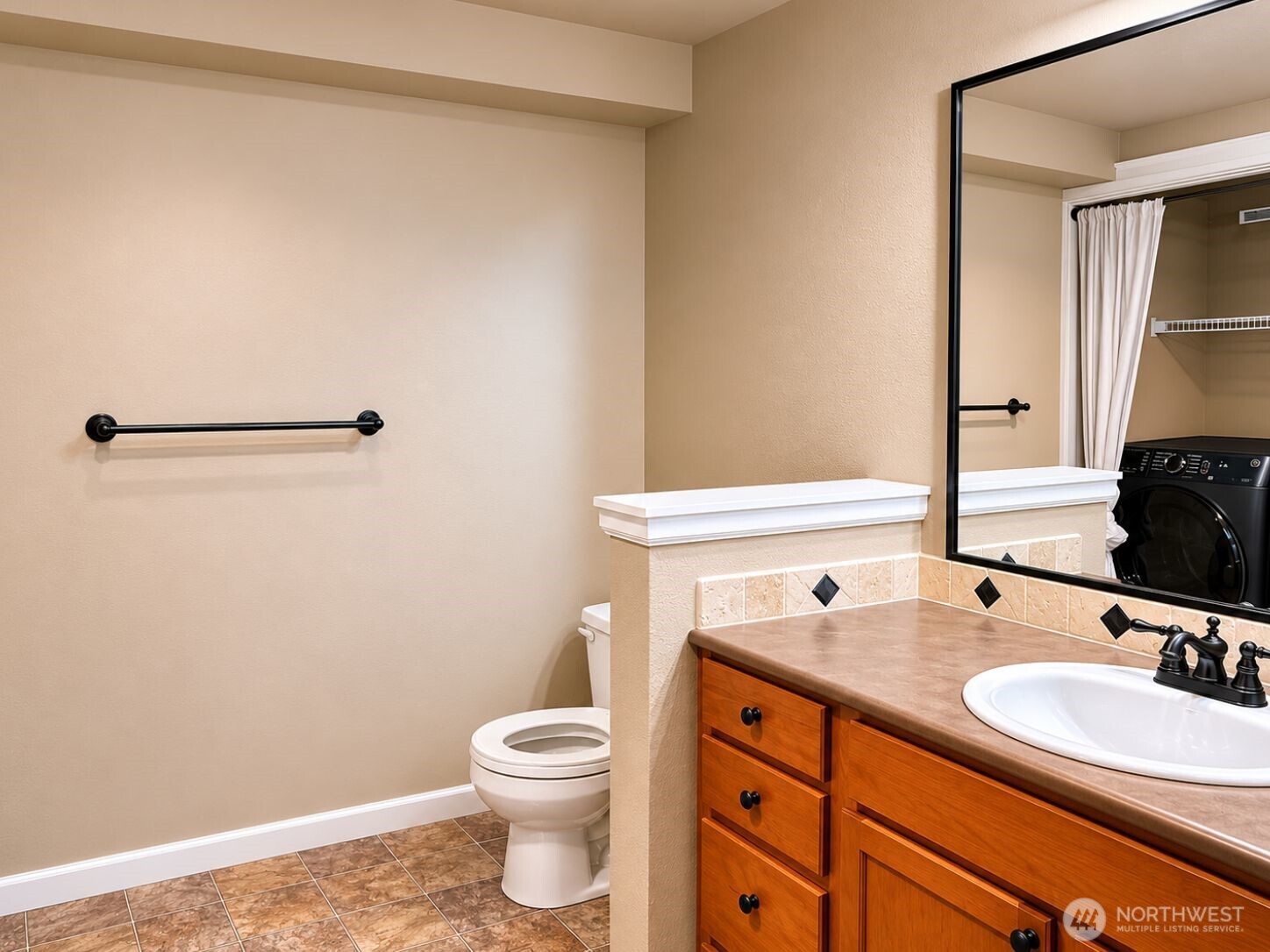 700 32nd Street, Unit A309 Bellingham, WA 98225 - Photo 14 of 28 a bathroom with a sink and a mirror