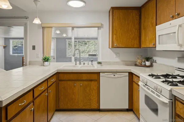 a kitchen with stainless steel appliances a sink stove and cabinets