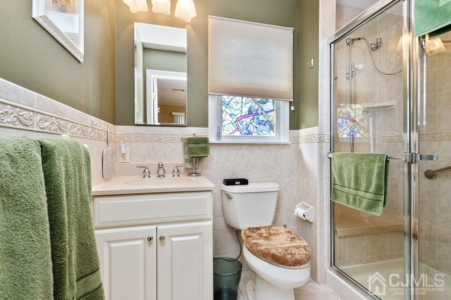 46 Weldon Road Edison, NJ 08817 - Photo 16 of 18 a bathroom with a sink a toilet and a shower