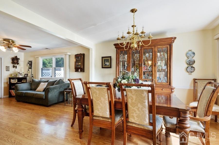 46 Weldon Road Edison, NJ 08817 - Photo 6 of 18 a dining room with furniture a chandelier and wooden floor