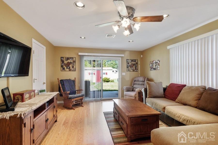 46 Weldon Road Edison, NJ 08817 - Photo 7 of 18 a living room with furniture a flat screen tv and a window