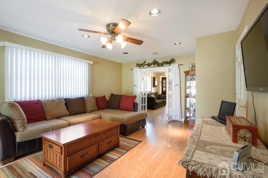 46 Weldon Road Edison, NJ 08817 - Photo 8 of 18 a living room with furniture a flat screen tv and a window