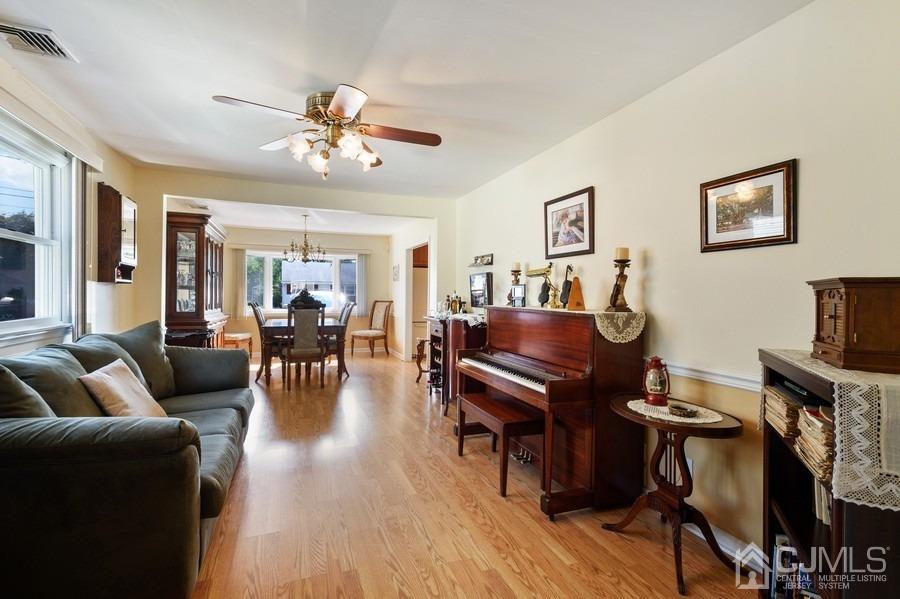 46 Weldon Road Edison, NJ 08817 - Photo 10 of 18 a living room with furniture a piano and a flat screen tv