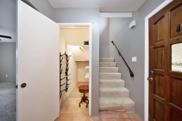 a view of a hallway with windows and entryway