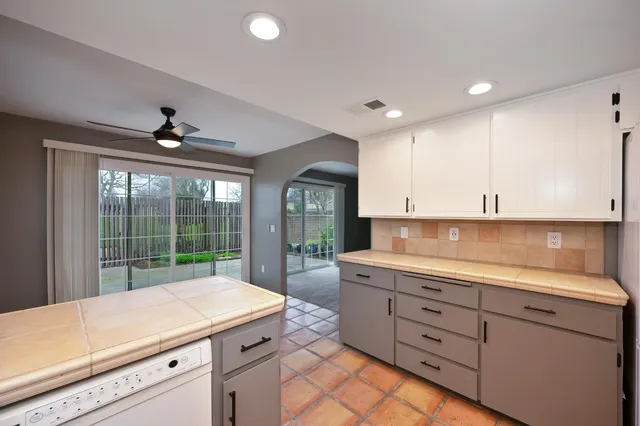 a kitchen with a sink and large window