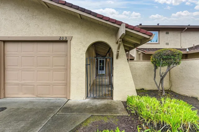 a front view of a house with a garden