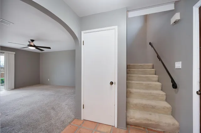 a view of an empty room with stairs