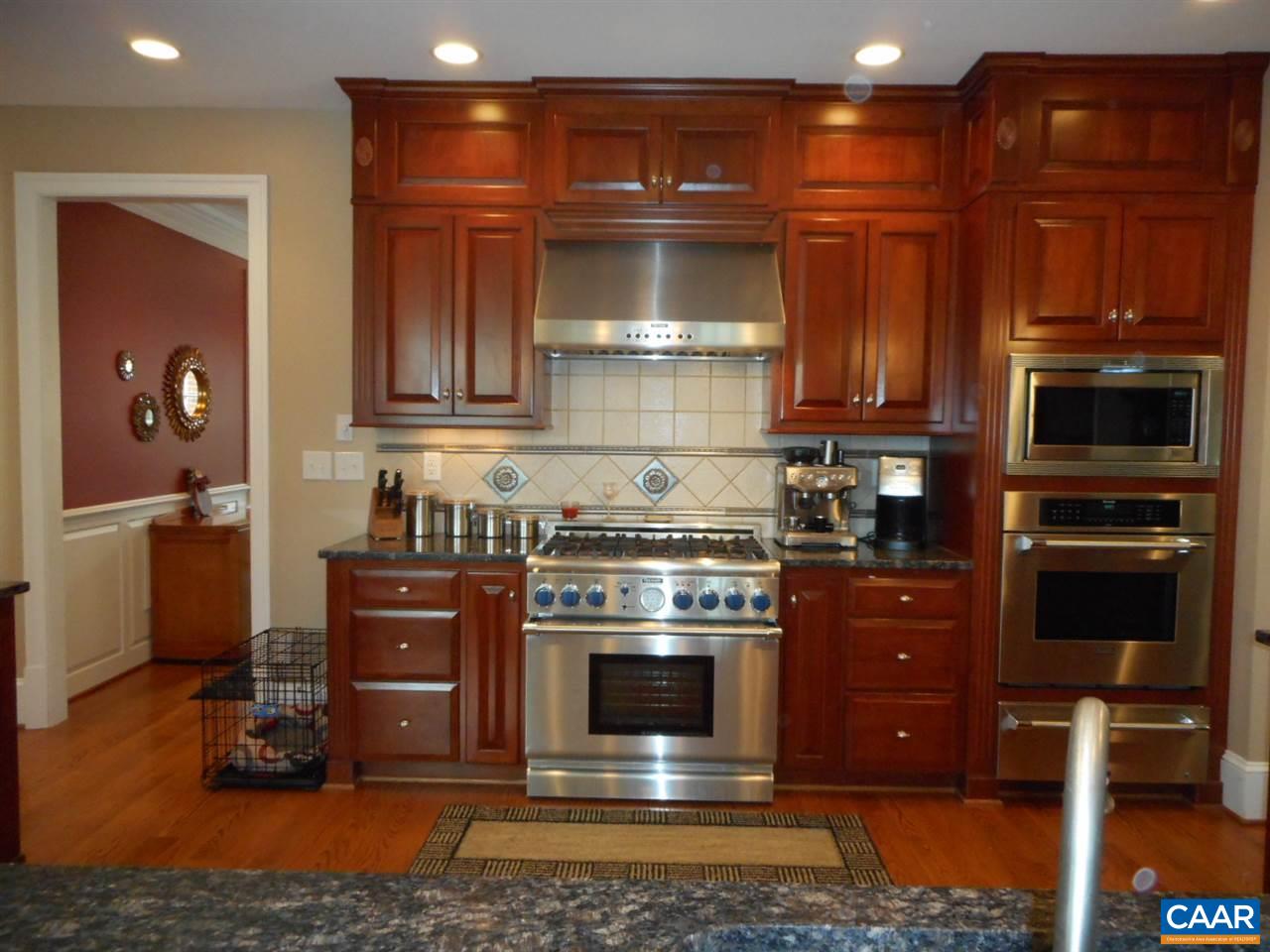 520 Rocks Farm Drive Charlottesville, VA 22903 - Photo 18 of 50 a kitchen with granite countertop a stove and a wooden cabinets