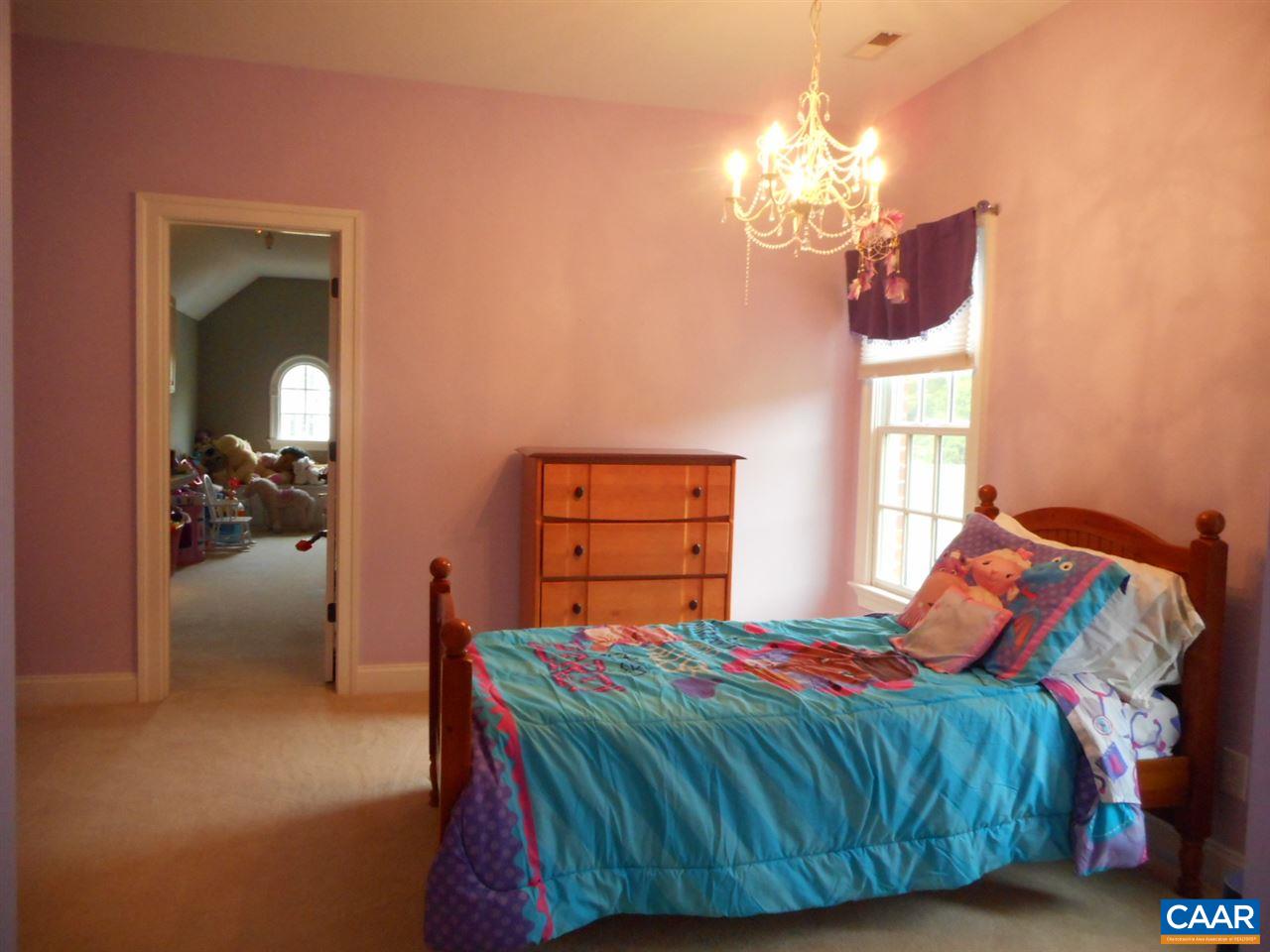 520 Rocks Farm Drive Charlottesville, VA 22903 - Photo 34 of 50 a bedroom with a bed and a chandelier