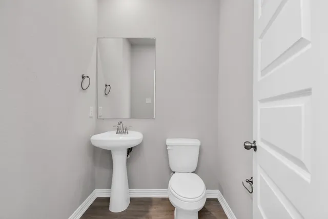 a bathroom with a sink toilet and a mirror