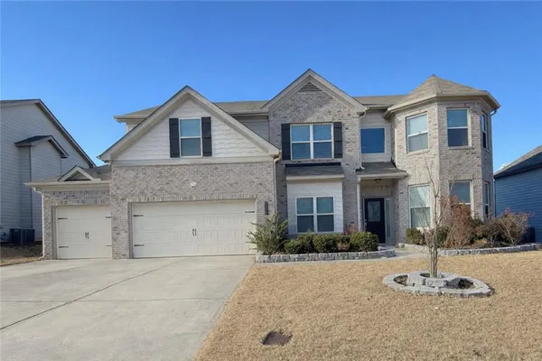 a front view of a house with a garage