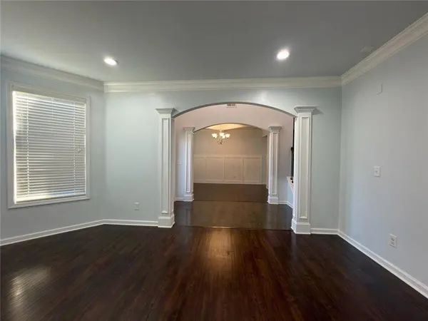 an empty room with wooden floor and a window
