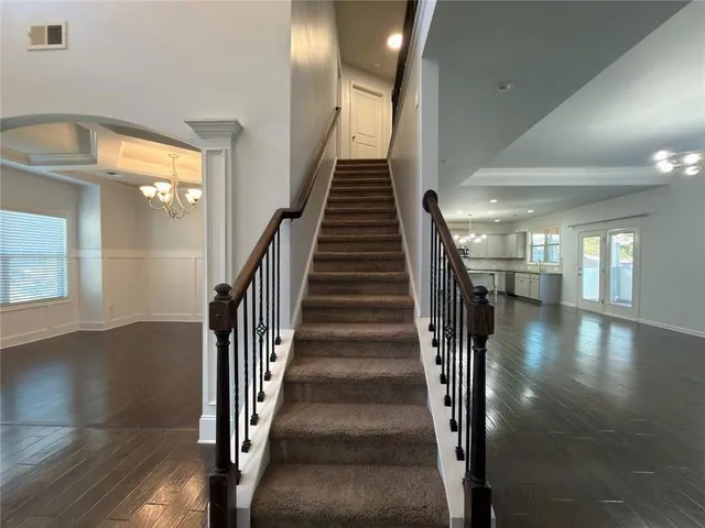 an empty room with a window and a ceiling fan