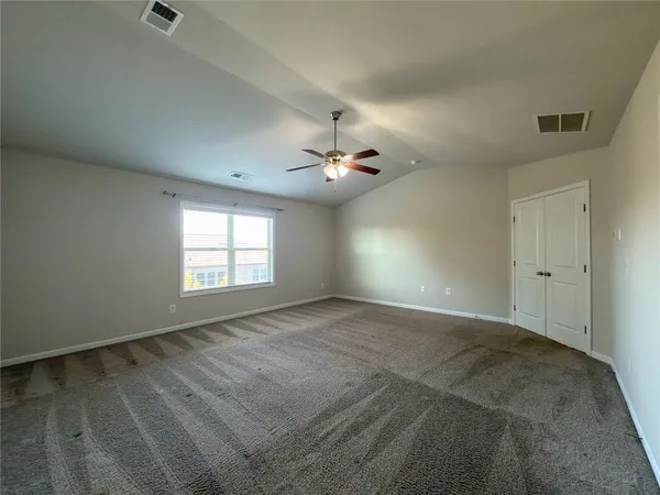 a spacious bathroom with a bathtub sink and mirror
