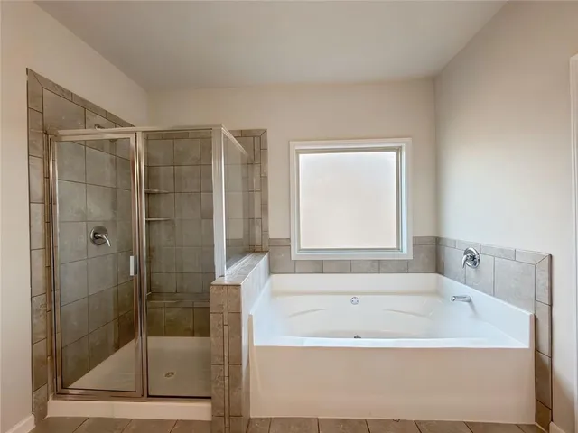 an empty room with windows and mirror