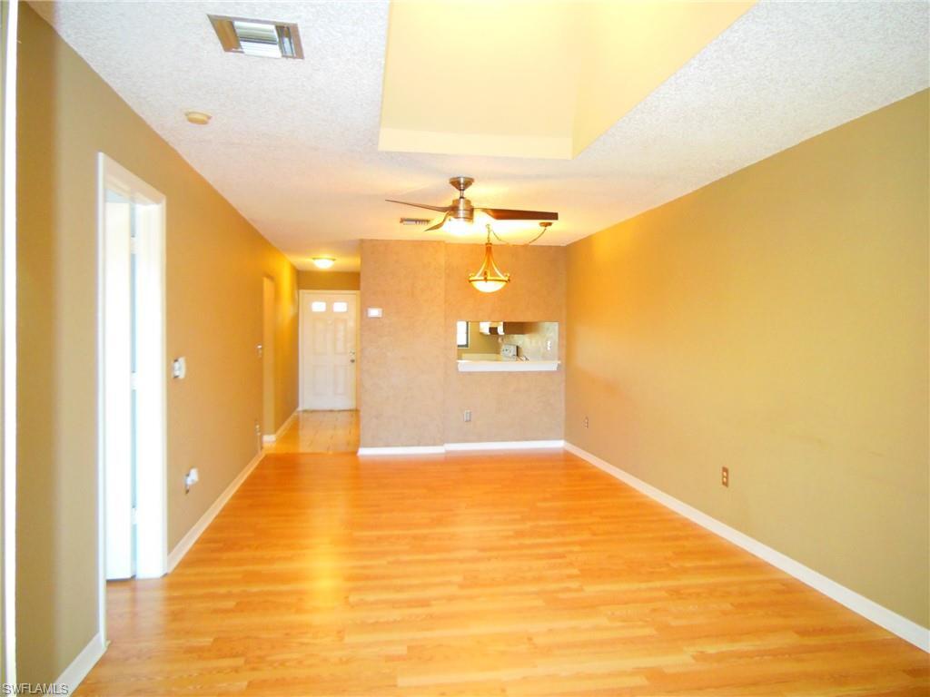 5327 Treetops Drive, Unit T205 Naples, FL 34113 - Photo 7 of 18 a view of a hallway with wooden floor
