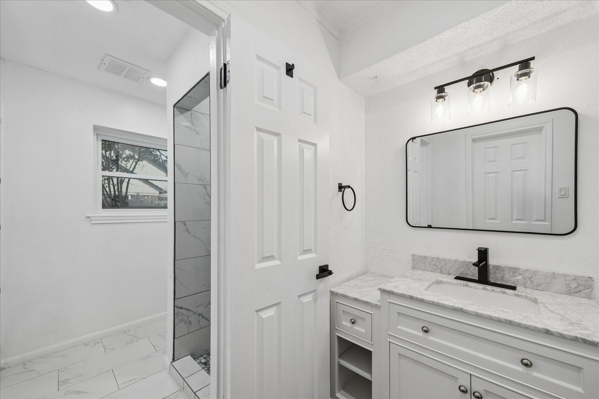 210 Weeping Oak Lane Spring, TX 77388 - Photo 12 of 20 a bathroom with a granite countertop sink a mirror and shower