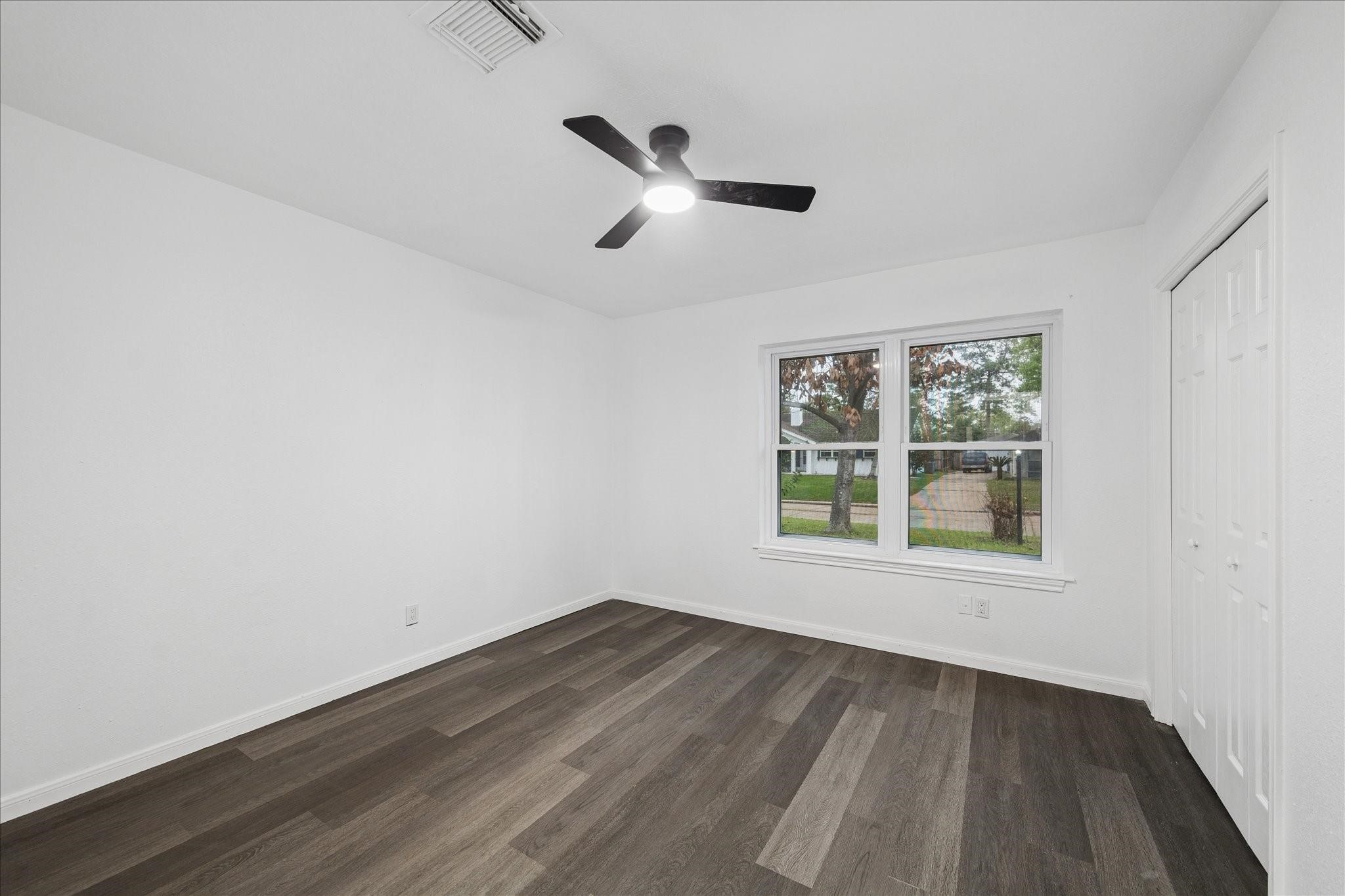 210 Weeping Oak Lane Spring, TX 77388 - Photo 16 of 20 an empty room with a window and wooden floor