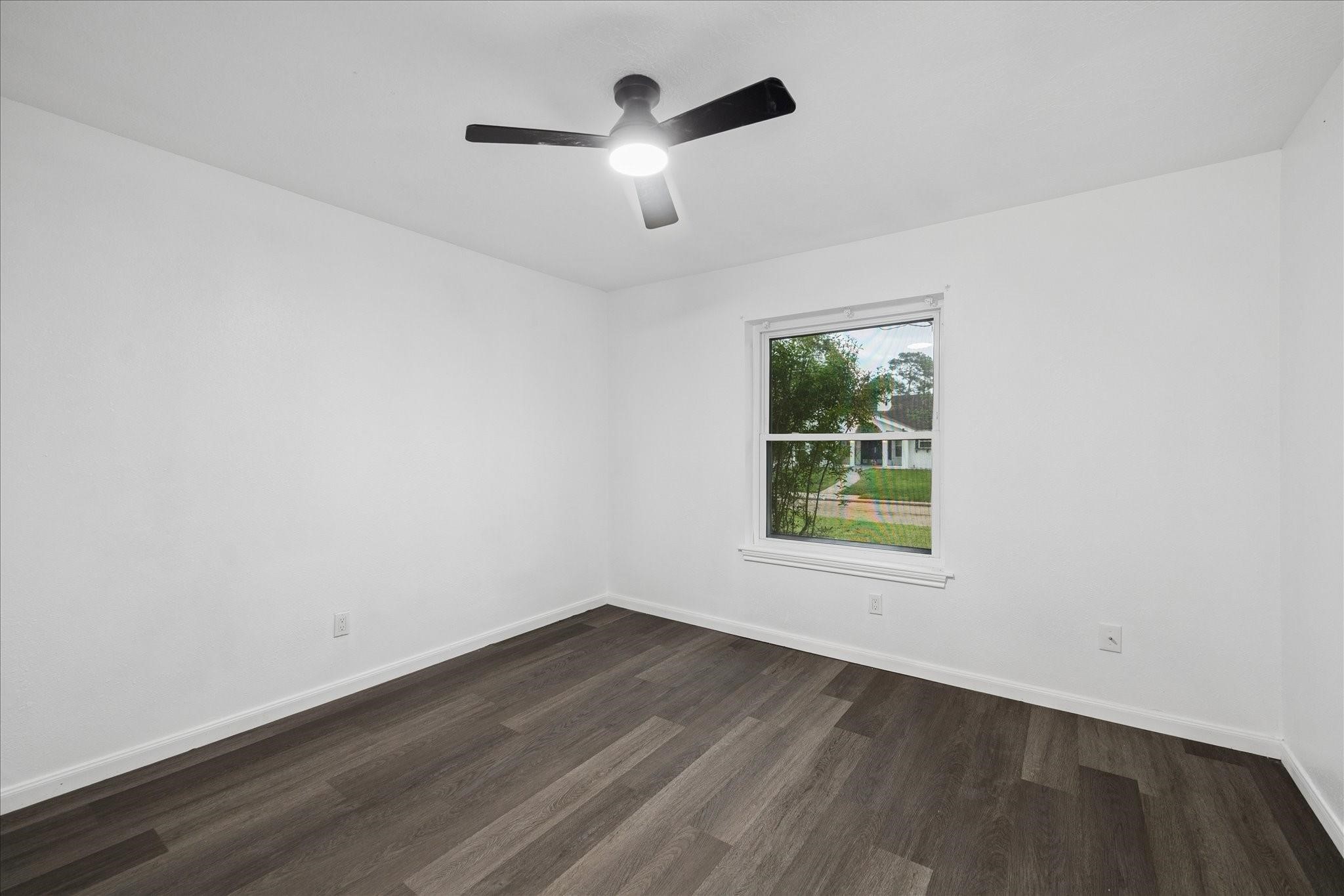 210 Weeping Oak Lane Spring, TX 77388 - Photo 17 of 20 an empty room with wooden floor and windows