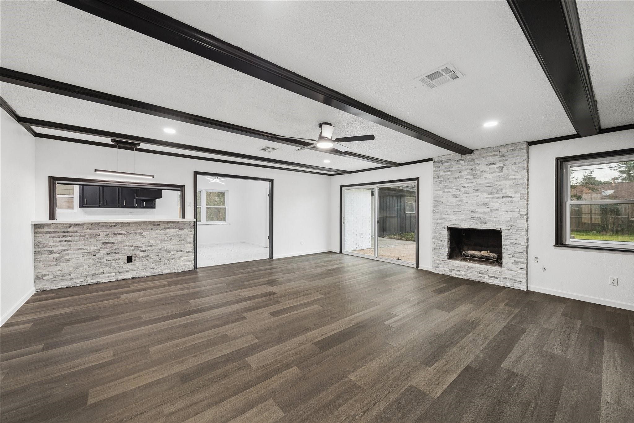 210 Weeping Oak Lane Spring, TX 77388 - Photo 4 of 20 a view of an empty room with wooden floor fireplace and a window