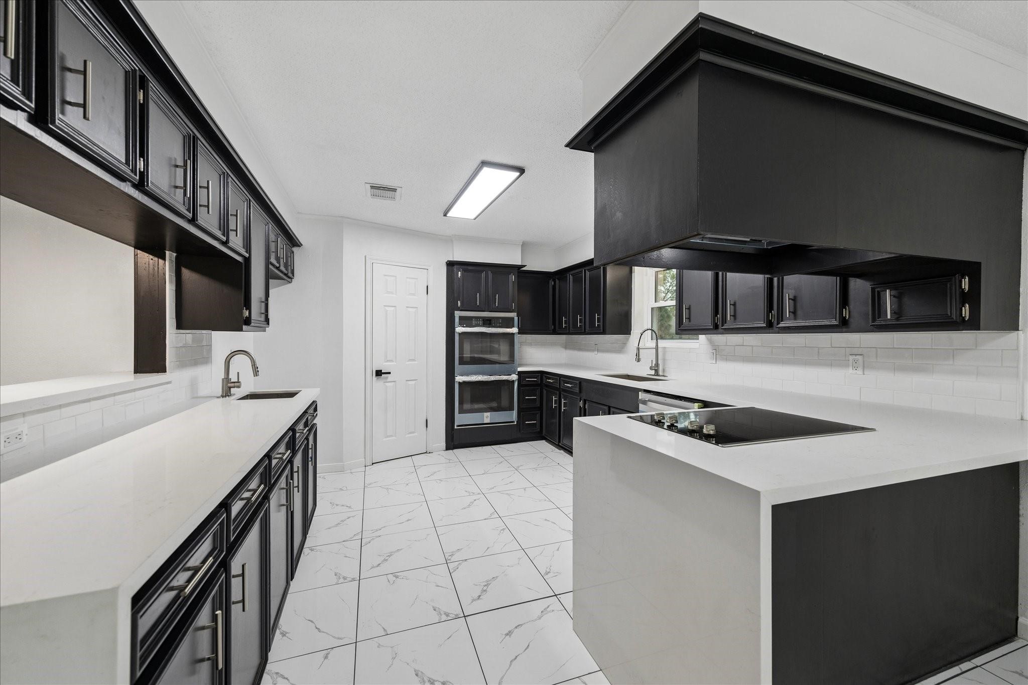 210 Weeping Oak Lane Spring, TX 77388 - Photo 5 of 20 a kitchen with stainless steel appliances a sink stove and cabinets