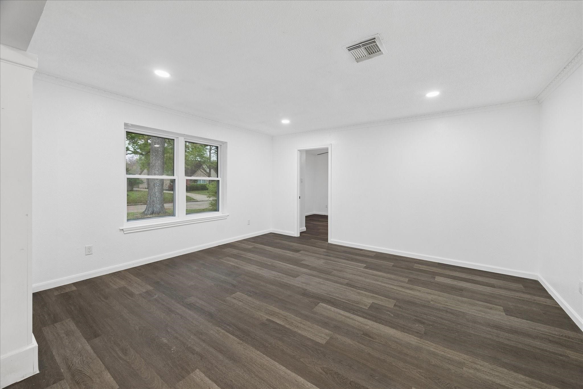 210 Weeping Oak Lane Spring, TX 77388 - Photo 8 of 20 a view of an empty room with wooden floor and a window