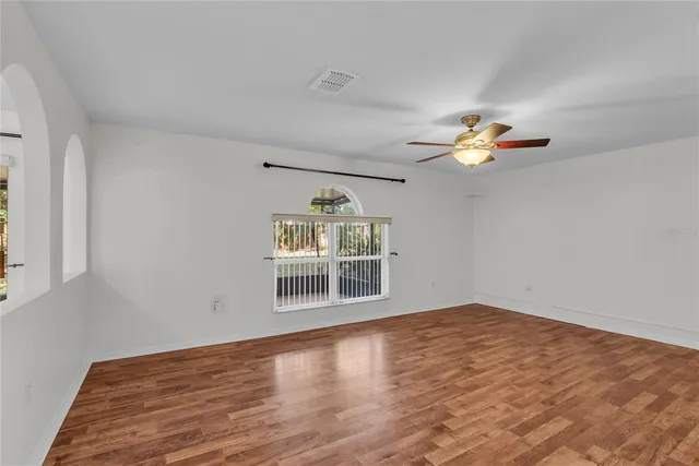 wooden floor in an empty room with a window